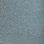 Close-up view of a densely looped textured fabric in bluish tones.