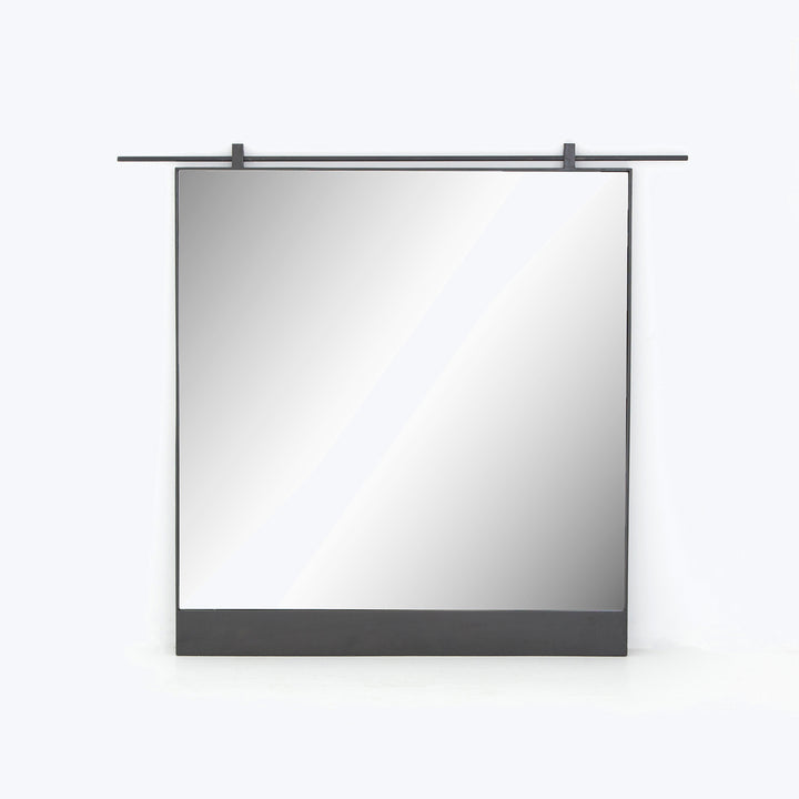Retracted projection screen in protective casing on white wall mount.
