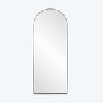 Modern minimalist arch-topped mirror reflecting light in sleek design.