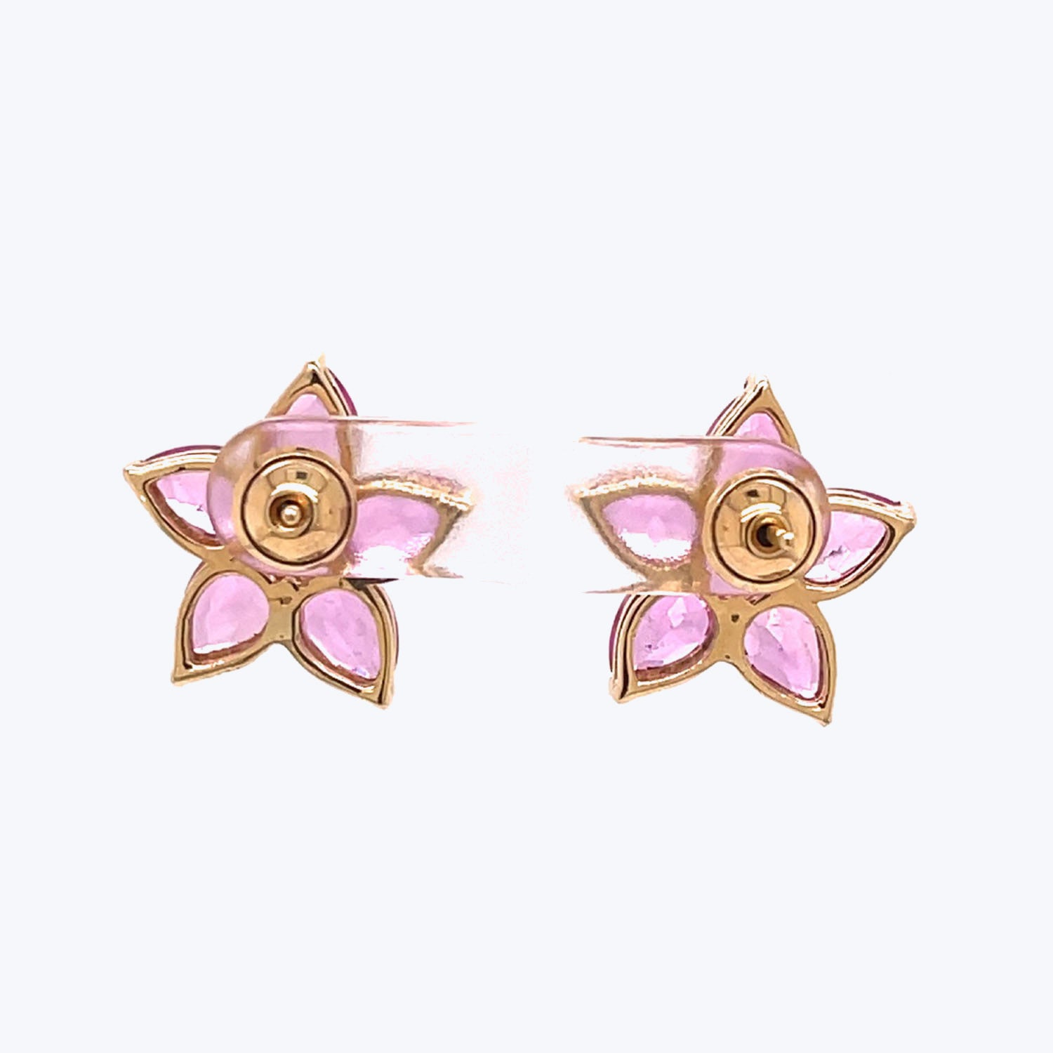Gold-tone flower earrings with pink petals and circular stigmas.