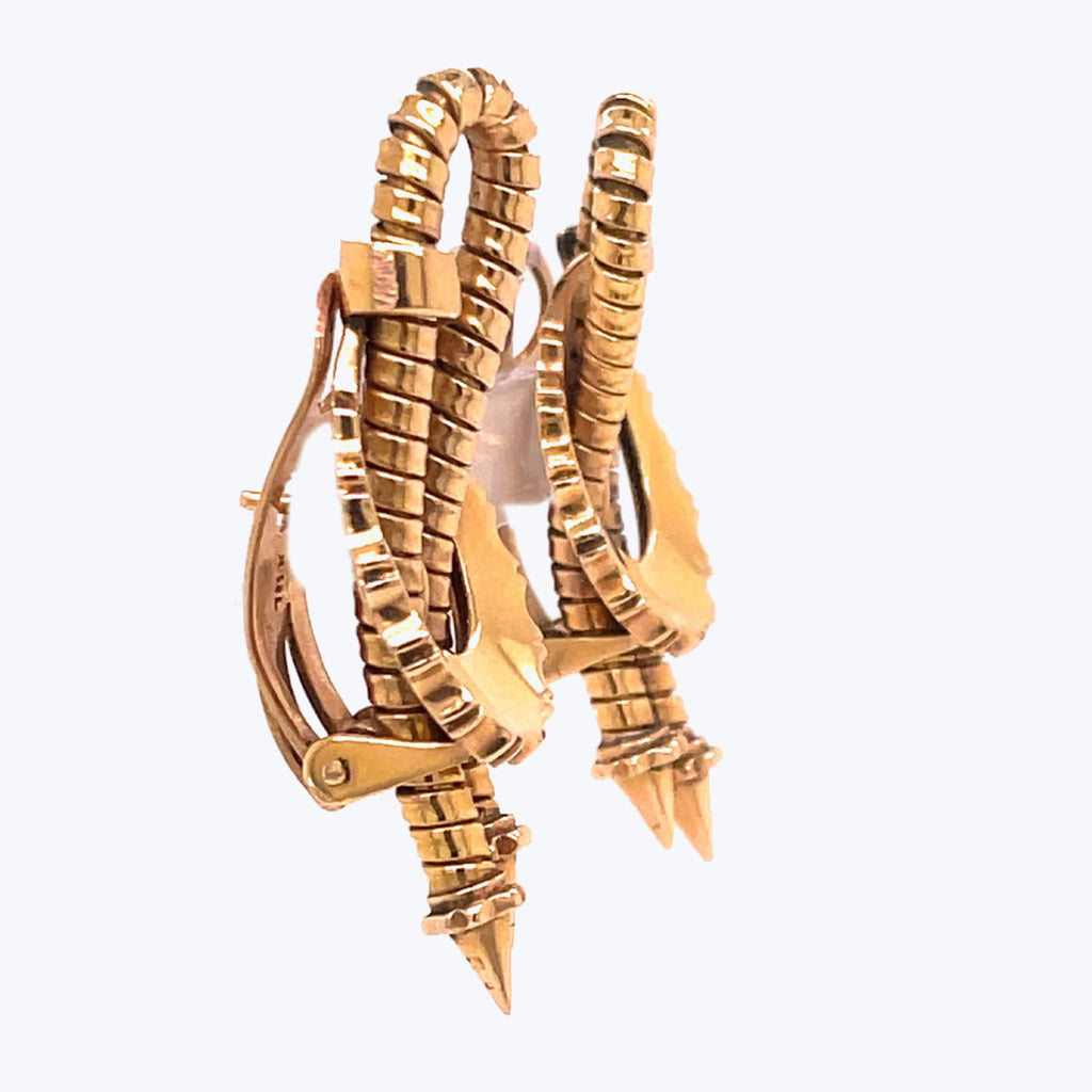 Golden hoop earrings with a unique reptilian-inspired design, luxurious statement piece.