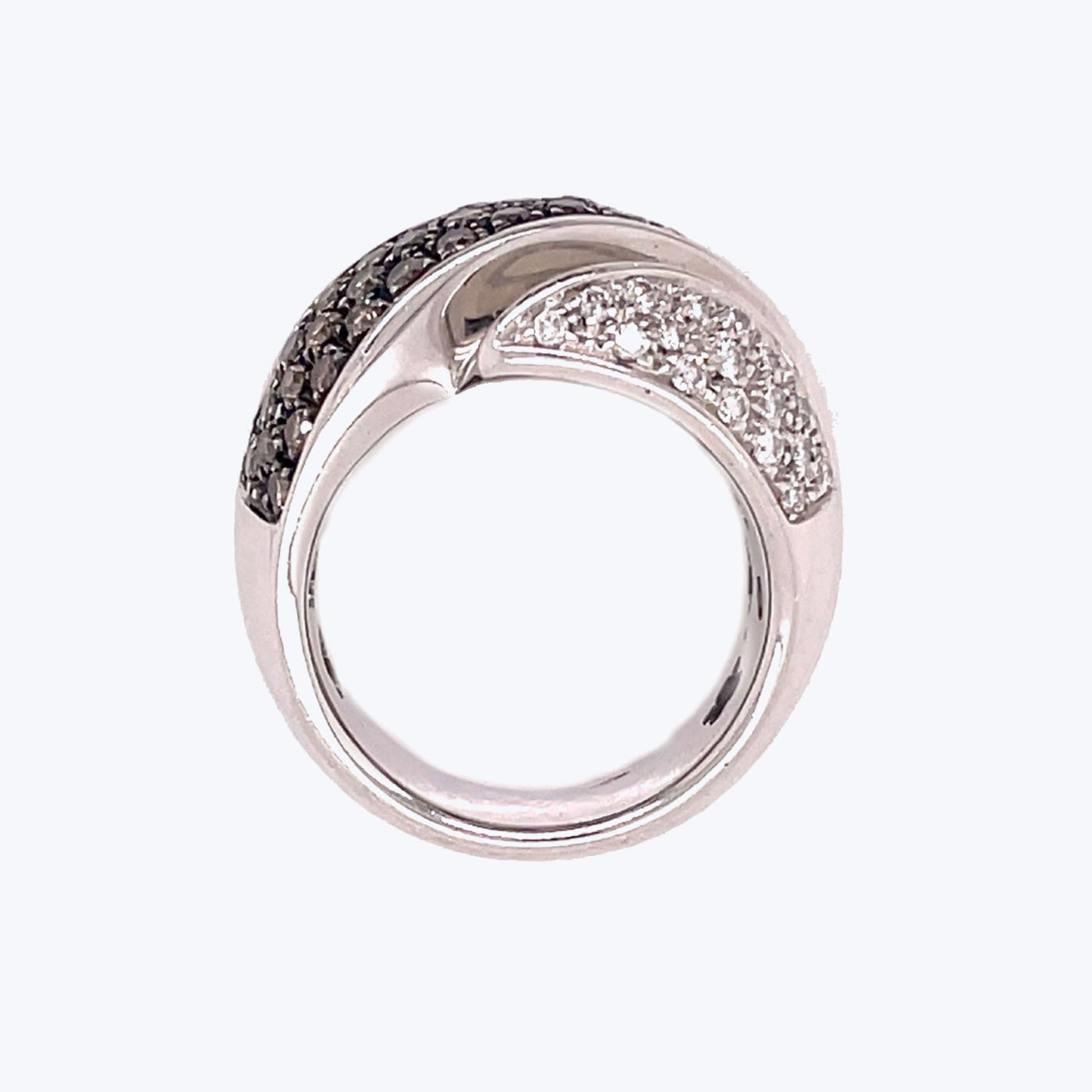 Silver ring with split band showcases contrasting gemstone encrusted sides.