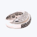 Intricately designed silver ring with sparkling diamond and black stone accents.