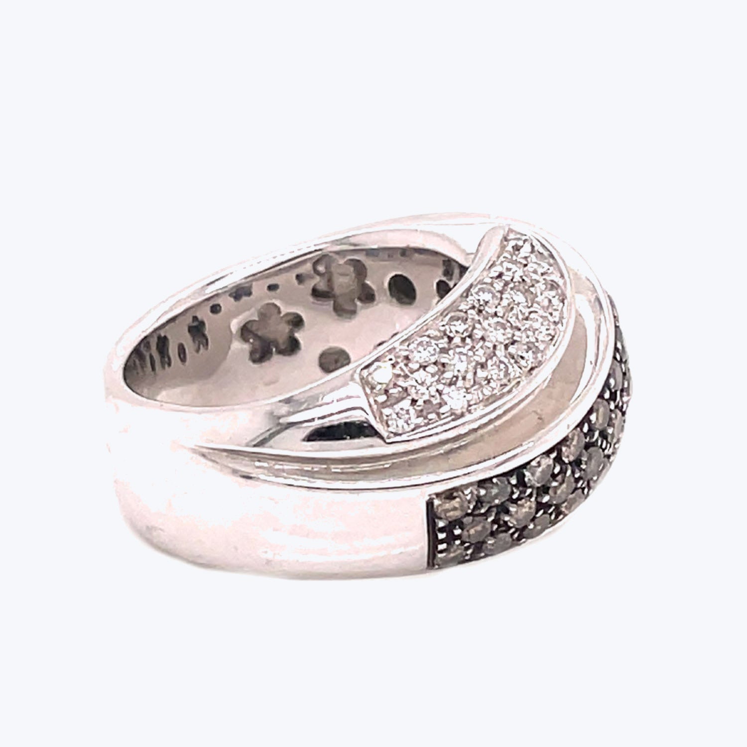 Intricately designed silver ring with sparkling diamond and black stone accents.