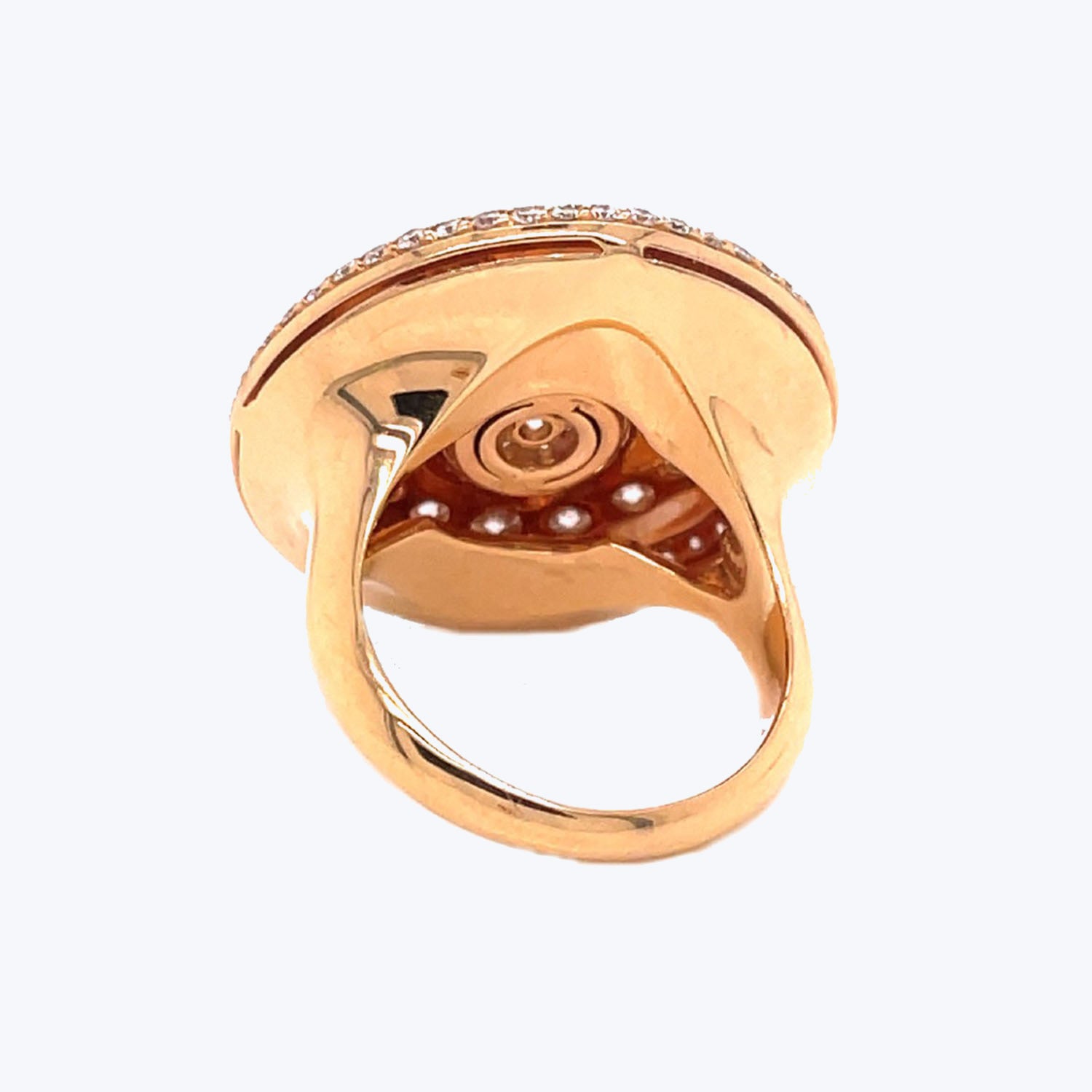 Elegant gold-toned ring with intricate swirling design and crystal embellishments.