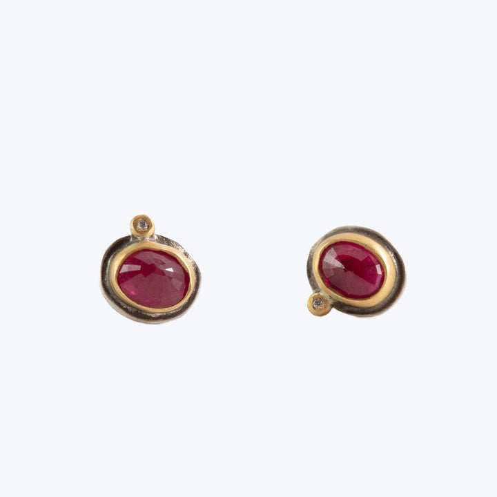 Vintage gold earrings with red gemstones and small accent detail.