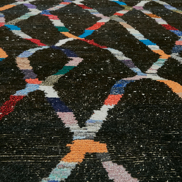 Vibrant patterned carpet with geometric diamond shapes on black background