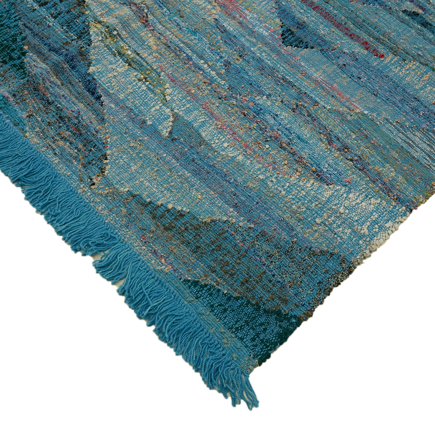 Vibrantly textured textile with shades of blue and distressed appearance.