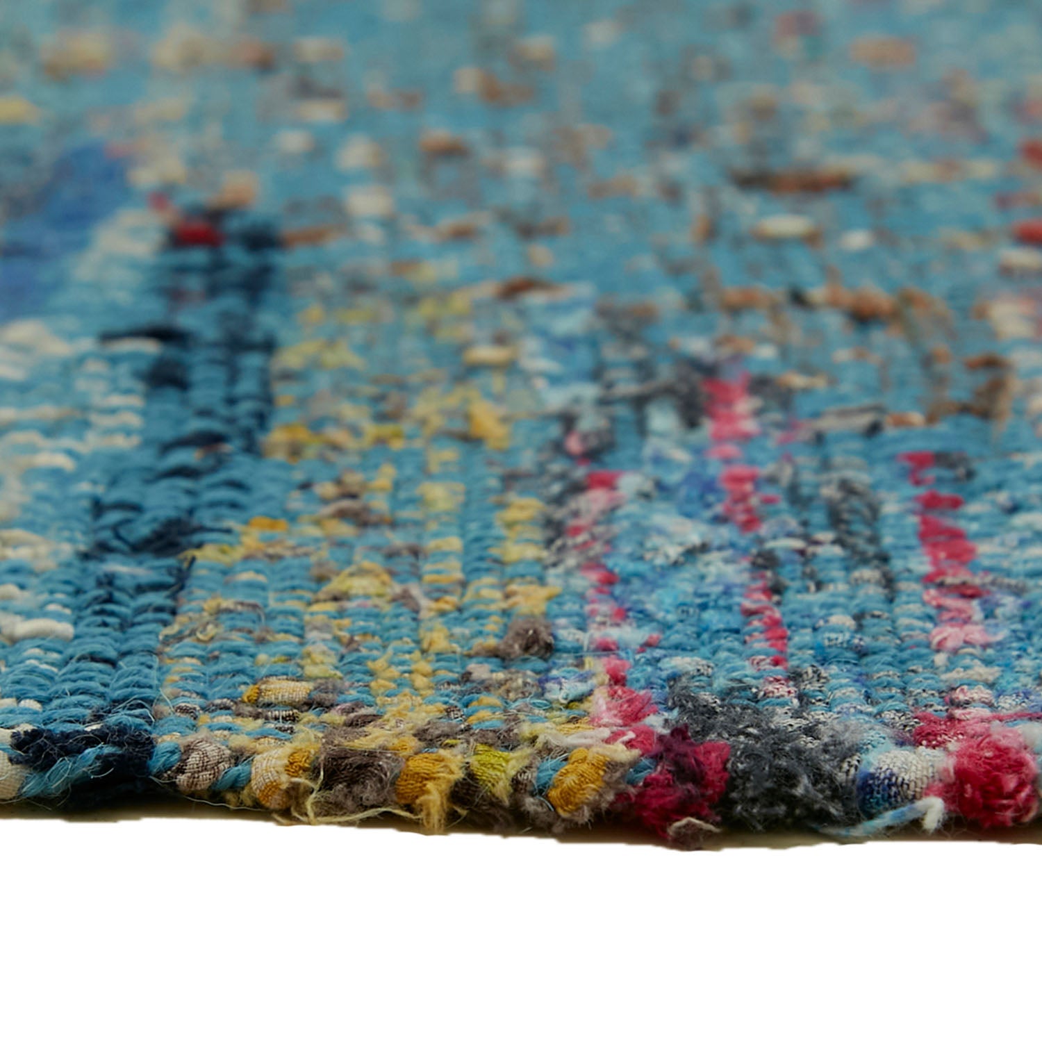 Close-up of a colorful, textured fabric with frayed yarn ends.