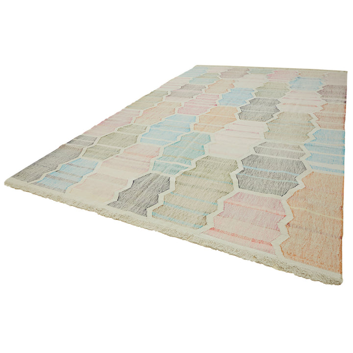 Rectangular area rug with interconnected hexagon pattern in pastel colors.