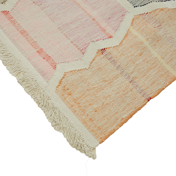 Close-up of a hand-woven textile rug with geometric pattern