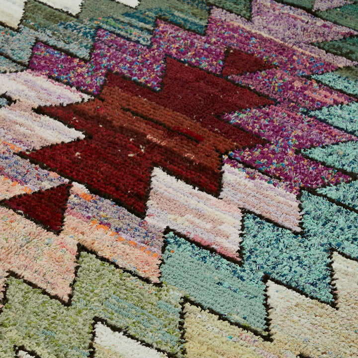 Vibrant, hand-woven textile with intricate zigzag pattern and varied colors.