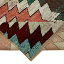 Close-up of a richly textured, handcrafted rug with geometric design