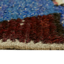 Close-up of plush, dense cream and red fabric with woven edge.