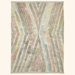 Abstract hand-woven rug with pastel geometric patterns and fringed edges.