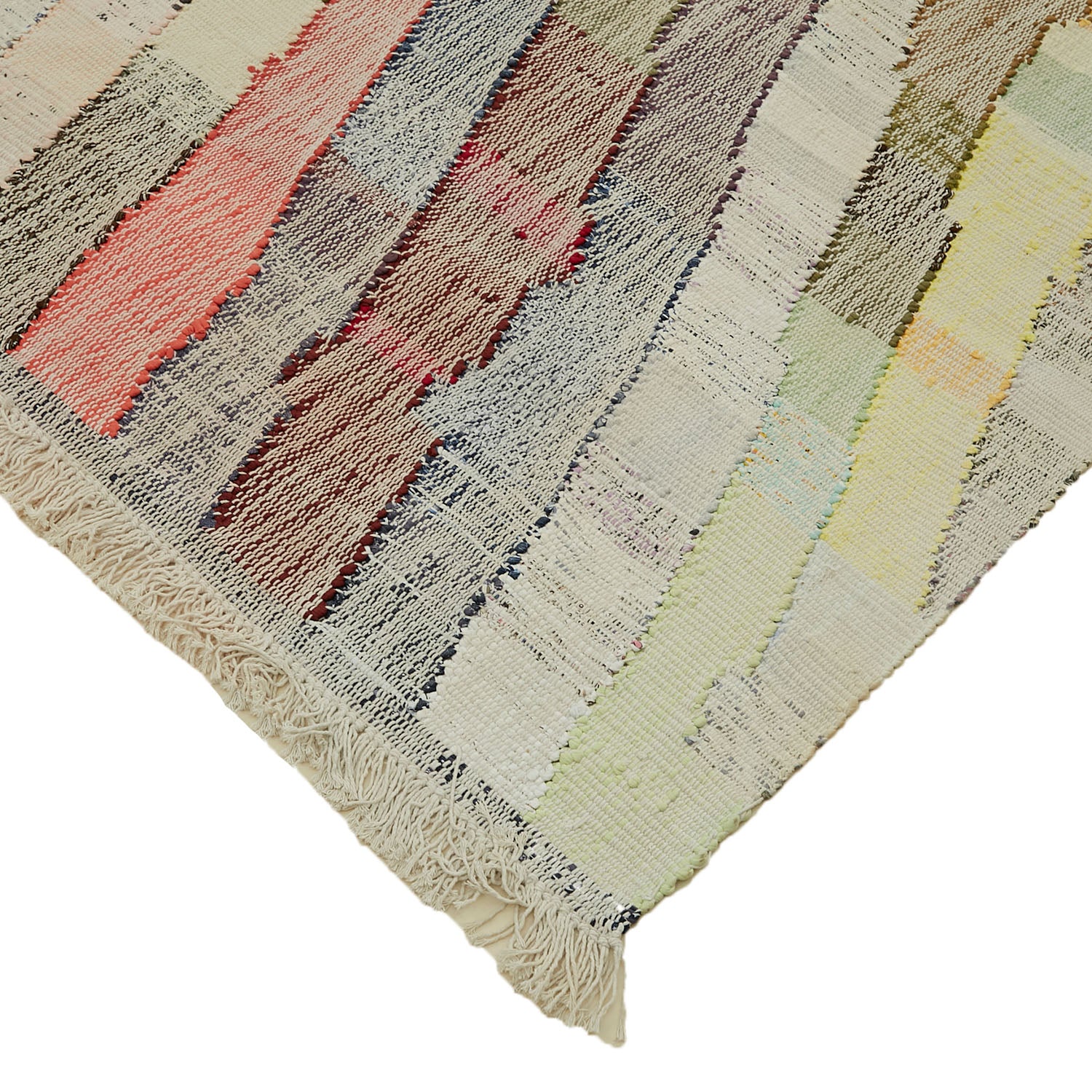 Handwoven rug with vibrant striped pattern and fringed edges displayed.