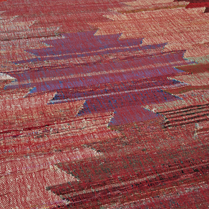 Vibrant, abstract woven fabric with intricate texture in red and blue.