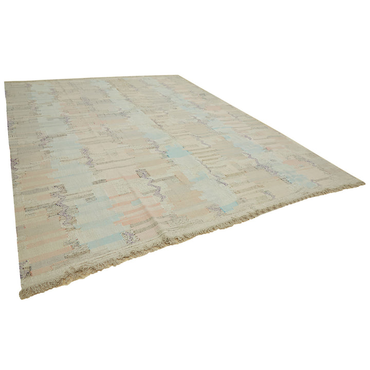 Modern distressed area rug with pastel colors and geometric motif.