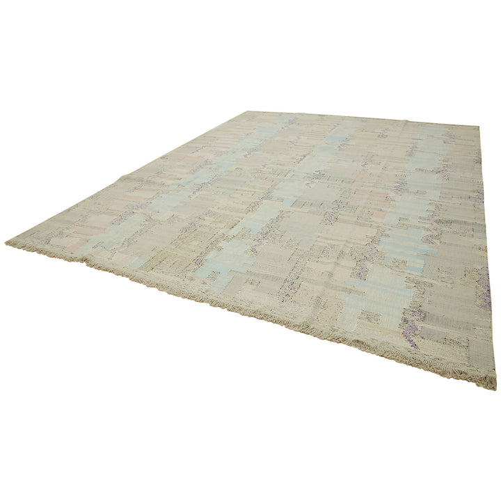 Vintage distressed rectangular rug with muted colors and fringe detail.