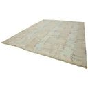 Vintage distressed rectangular rug with muted colors and fringe detail.