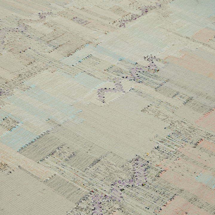 Textured woven textile showcasing delicate pastel colors and intricate pattern.
