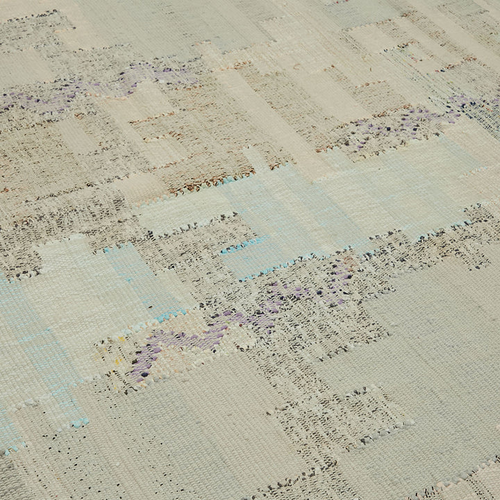 Close-up of worn, textured fabric with plaid-like pattern