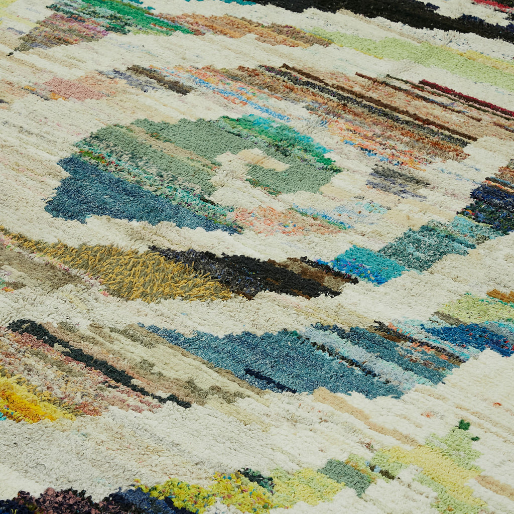 Close-up of vibrant, textured, handwoven rug with rich abstract pattern