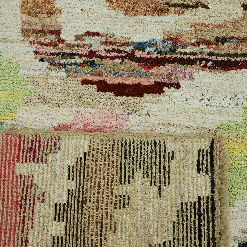 Caption: Close-up of a rug or textile art with contrasting textures and patterns.