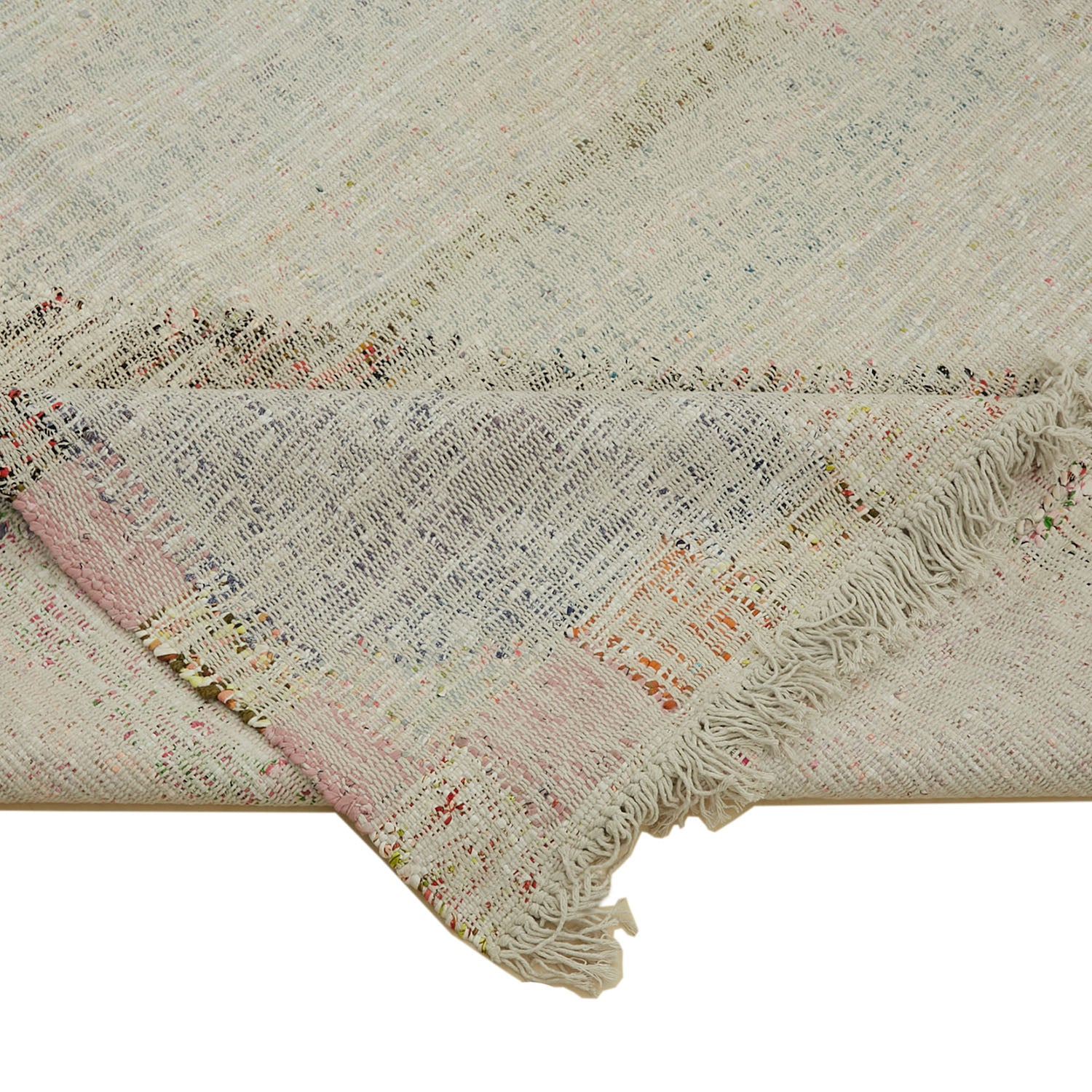 Close-up shot of a textured off-white fabric with multi-colored threads.