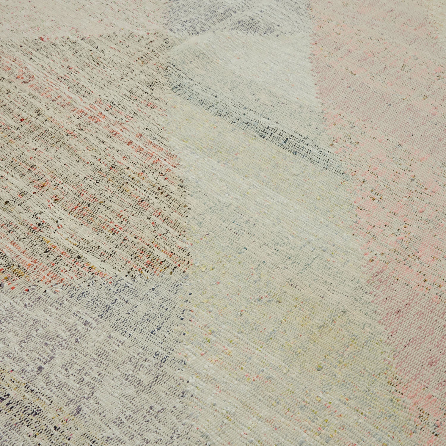 Close-up of a handwoven fabric with a vibrant, textured weave.