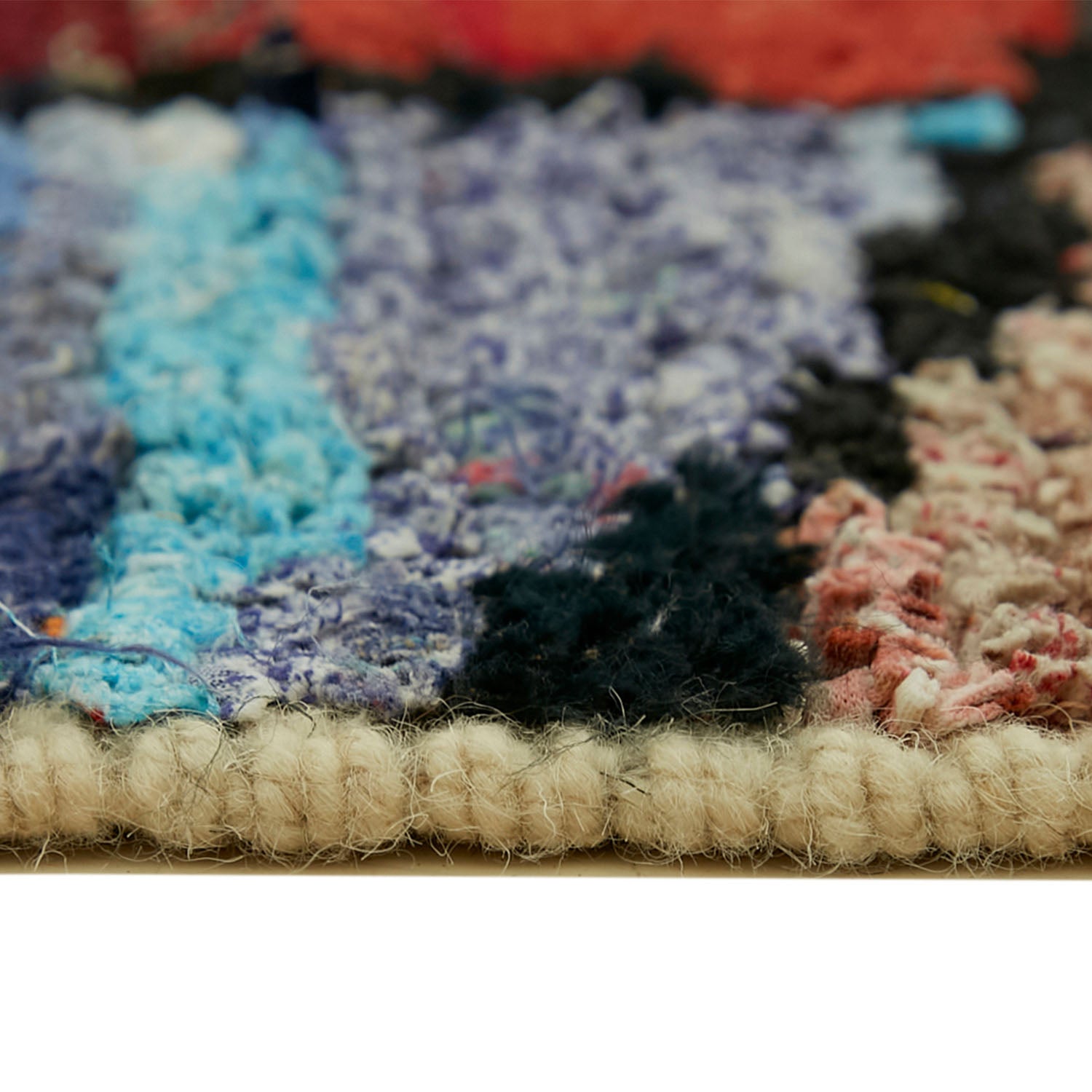 Vibrant and textured rug with a mix of colorful yarns.