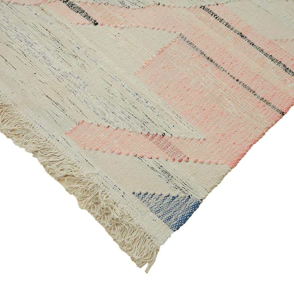 Close-up of a handwoven, natural fiber rug featuring geometric pattern