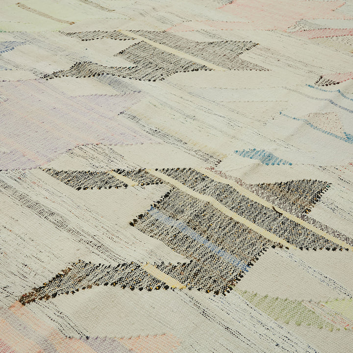 Close-up of intricate woven pattern with interlocking chevrons and subtle hues