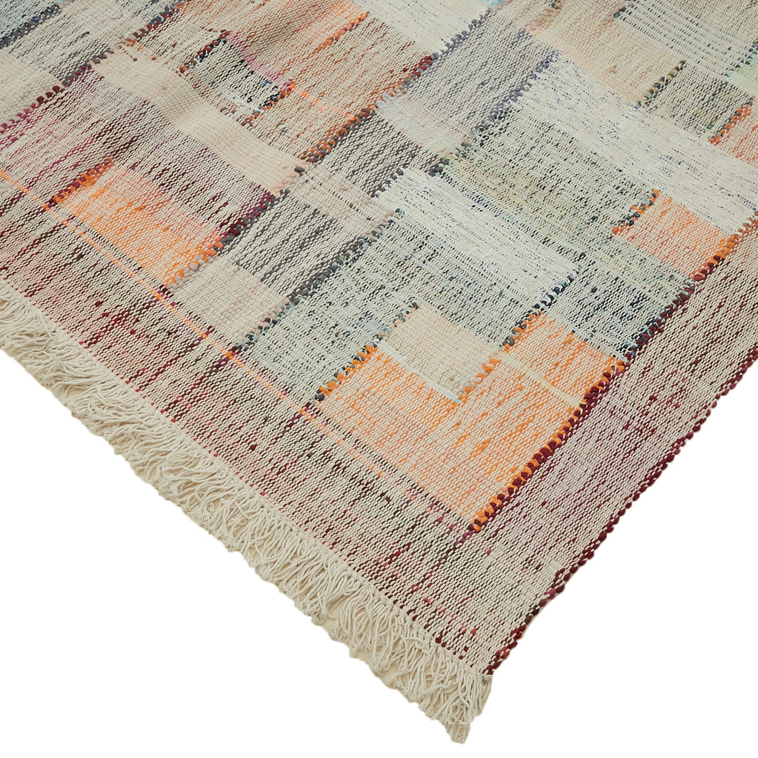 Colorful flatwoven rug with abstract geometric pattern and fringed edges.