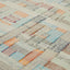 Close-up of textured, handwoven rug with colorful, varied stripes.