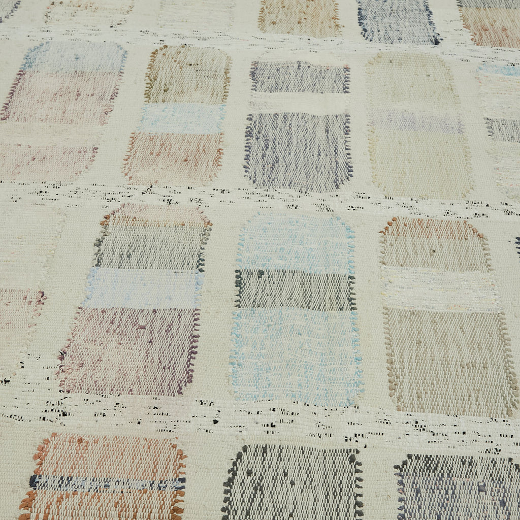 Detailed view of a handcrafted patchwork textile with rustic charm.