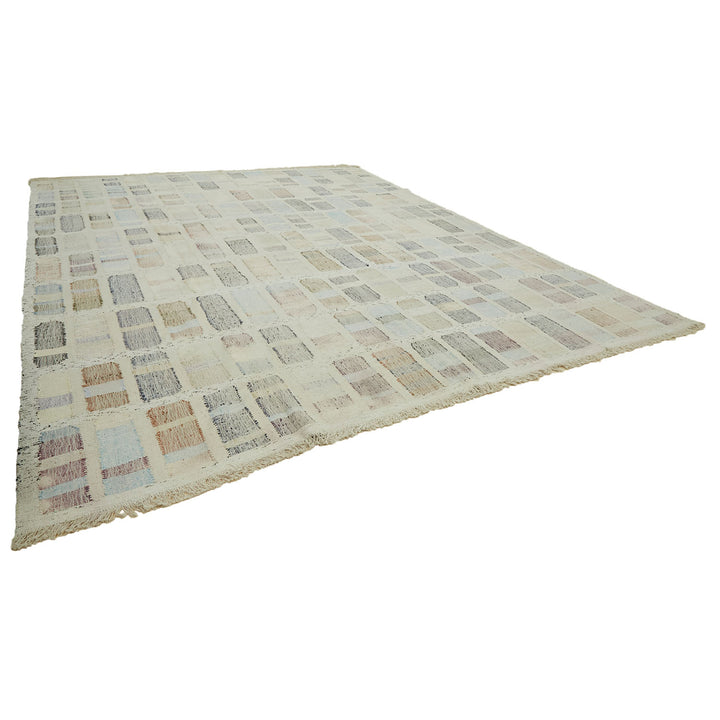 Rectangular area rug with grid pattern in muted colors
