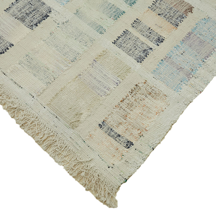 Close-up of a vibrant patchwork rug with intricate weaving patterns