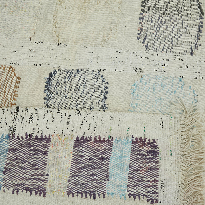 Handcrafted textile with multi-textural and colorful design for home decor.
