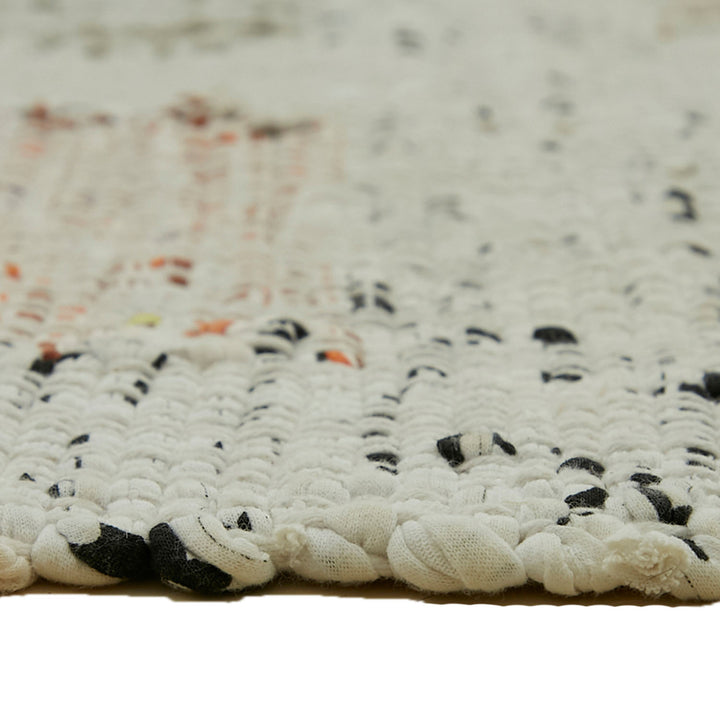 Close-up of textured fabric with looped weave and knotted style.