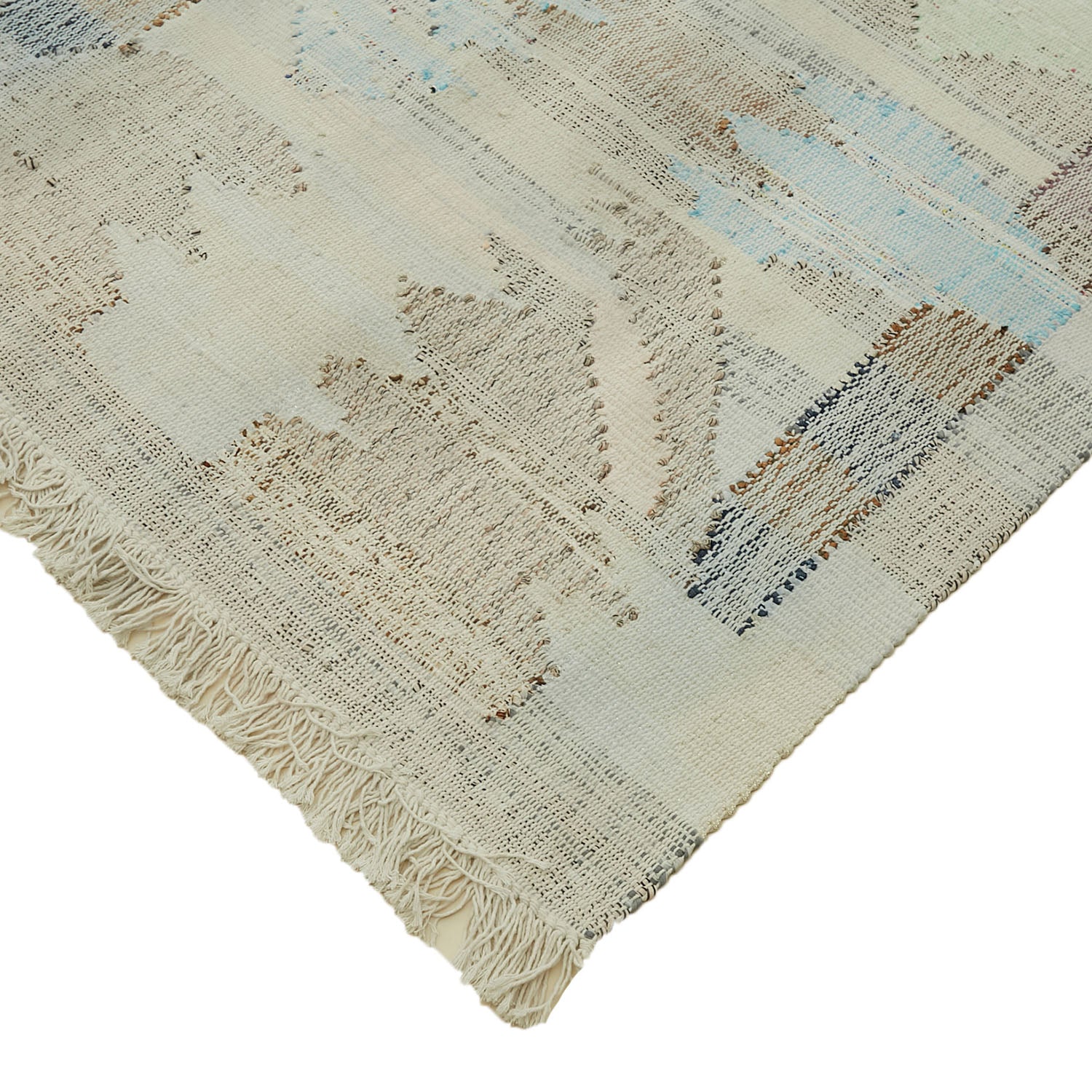 Close-up of hand-crafted rug with contemporary, abstract pattern in soft hues.