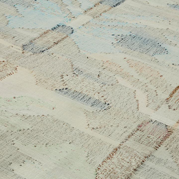 Intricate, pastel-striped fabric showcases skilled craftsmanship and varied textures.