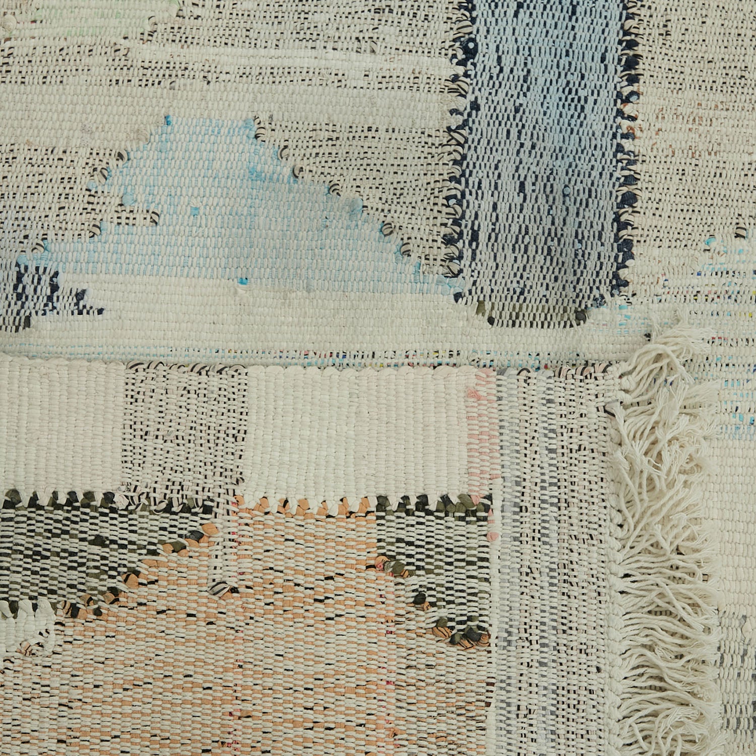 Close-up view of a handcrafted woven textile with varied textures