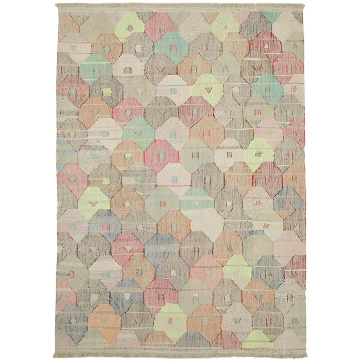 Colorful quilt with tessellated pattern showcases intricate handwork and cultural heritage.