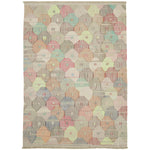 Colorful quilt with tessellated pattern showcases intricate handwork and cultural heritage.