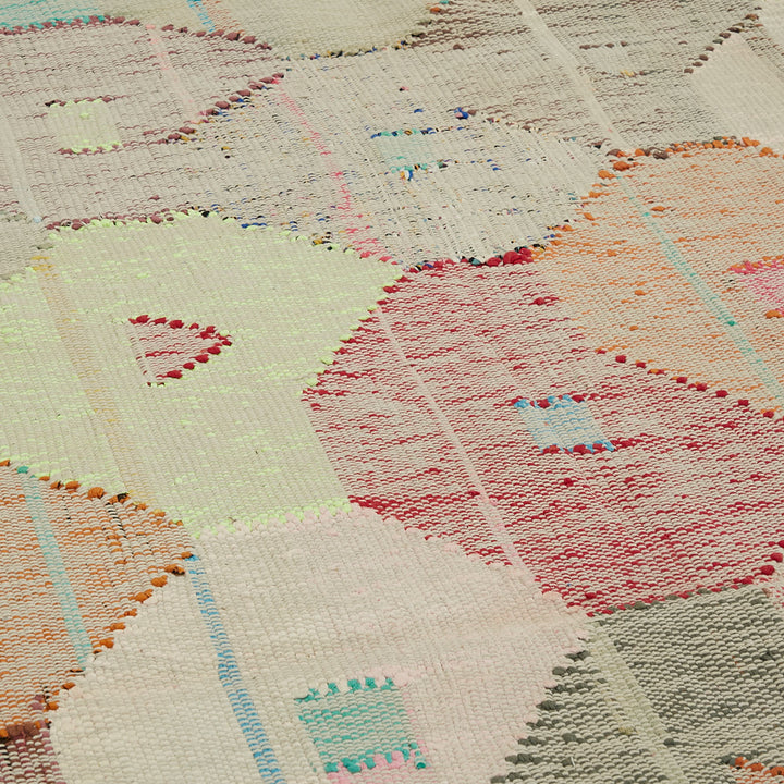 Close-up of a hand-crafted quilt with vibrant geometric patterns.