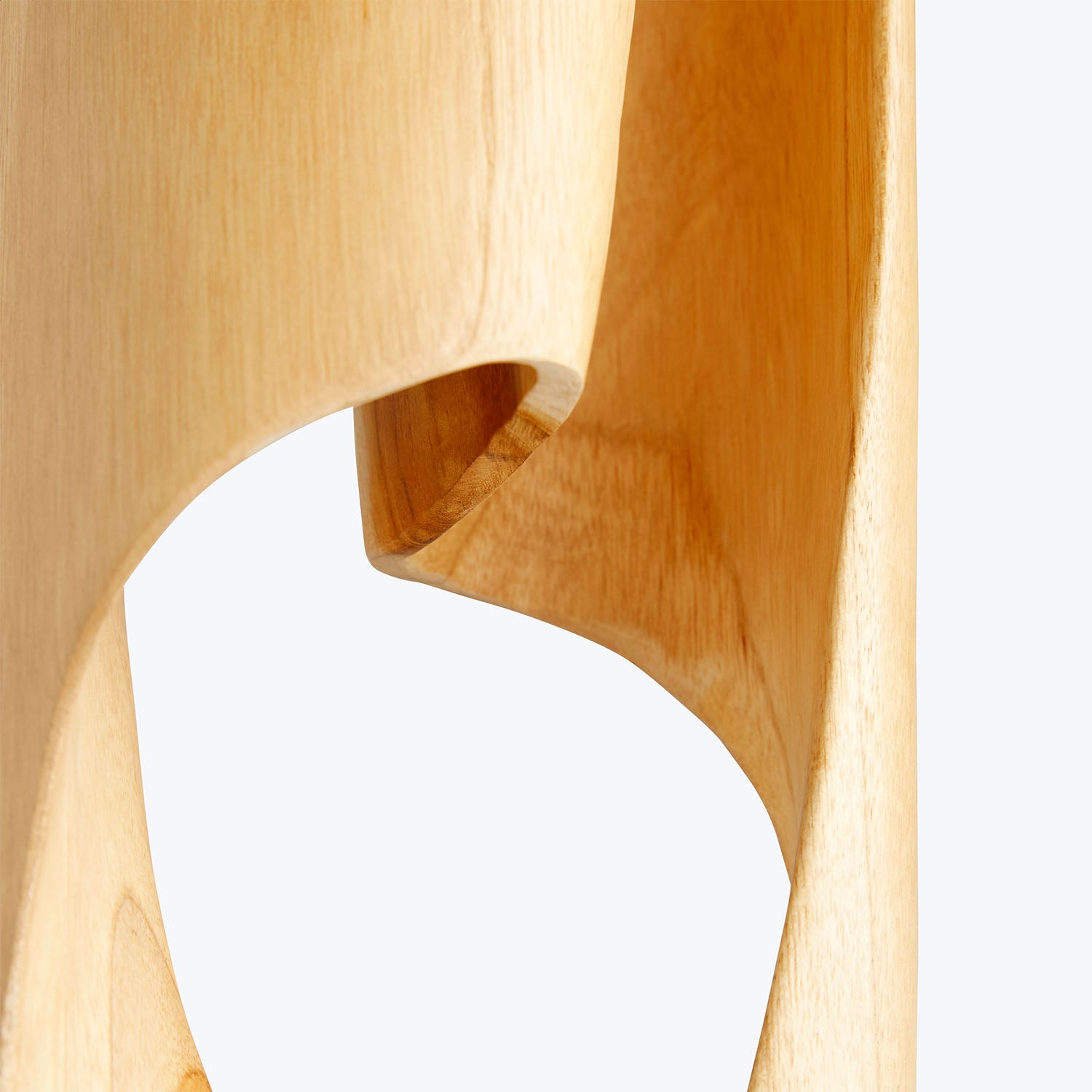 Close-up of a beautifully crafted wooden object with smooth curves.