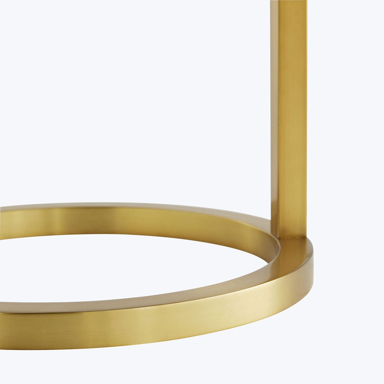 Golden circular structure connected to vertical rod, minimal and modern design.