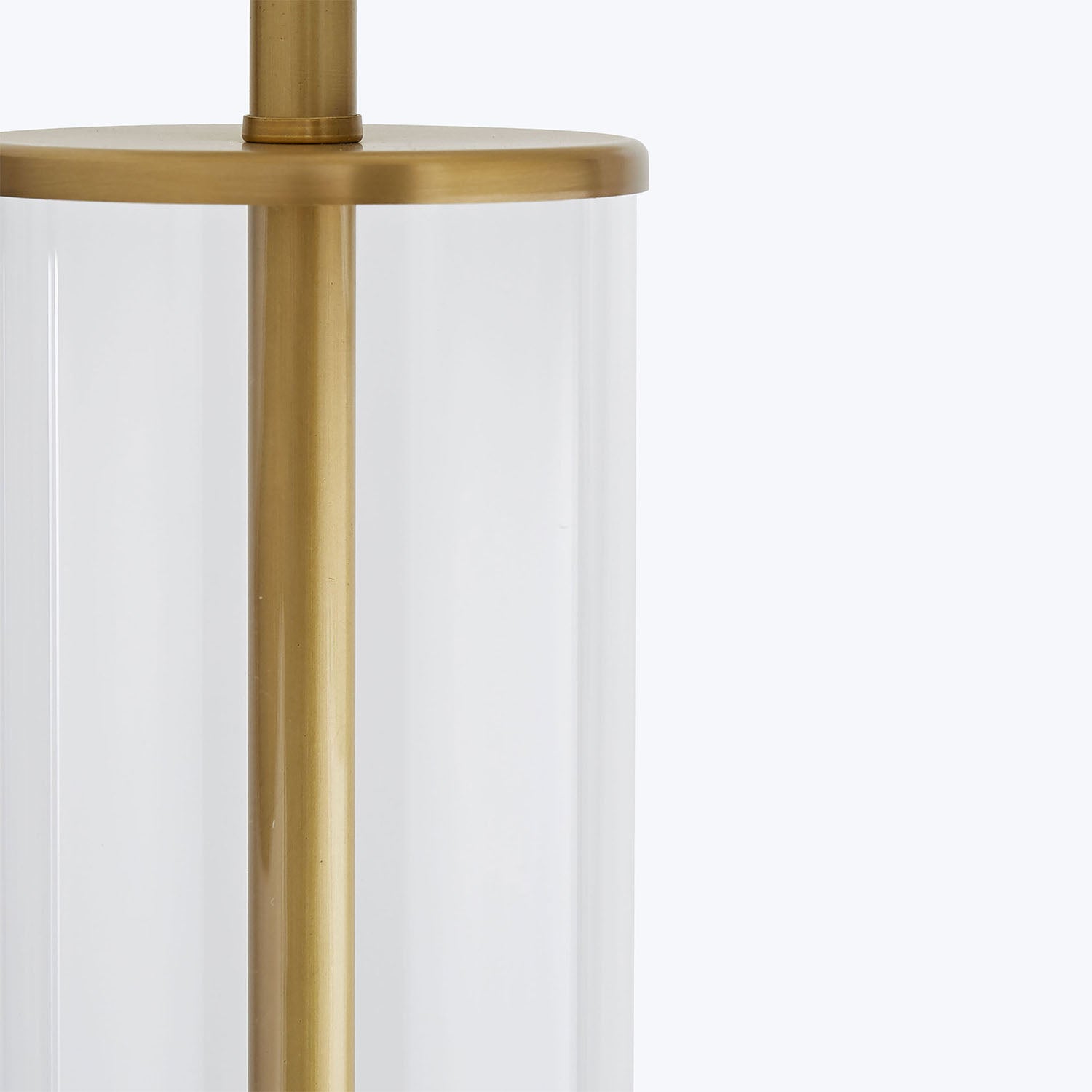 Close-up of a brass lamp structure with clear glass element.