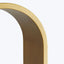 Close-up of lustrous metallic curved structure with golden brass-colored edge.